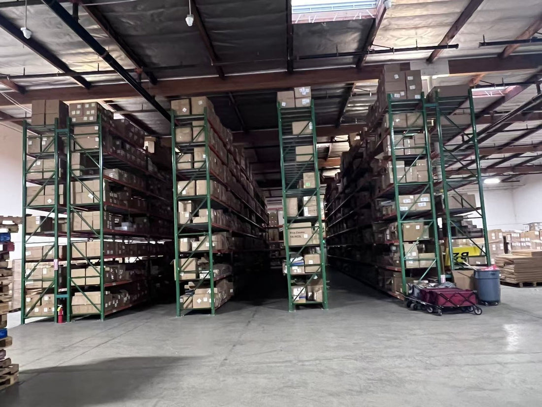 Warehouse aisle with tall green pallet racking stacked with cardboard cartons